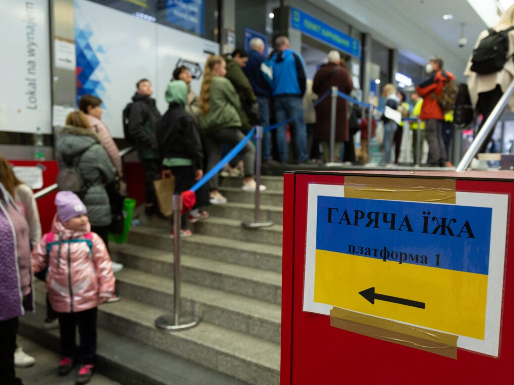 Ukrainian refugees wait for food