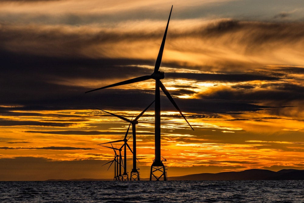 offshore wind farms in sun rise or sunset